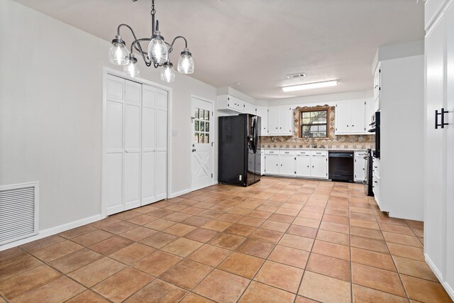 kitchen with backsplash, black appliances, decorative light fixtures, a chandelier, and white cabinetry