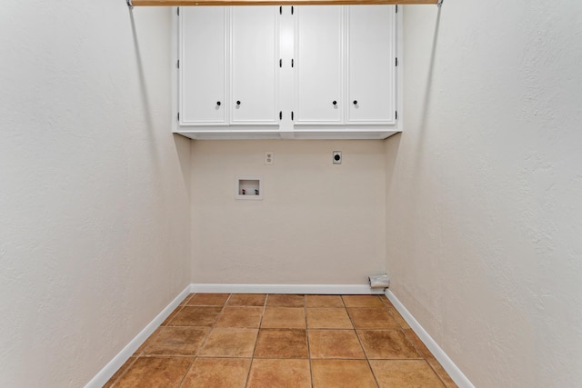 laundry area with hookup for an electric dryer, cabinets, light tile patterned floors, and washer hookup