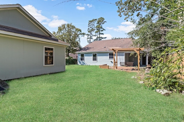 back of house featuring a pergola and a yard