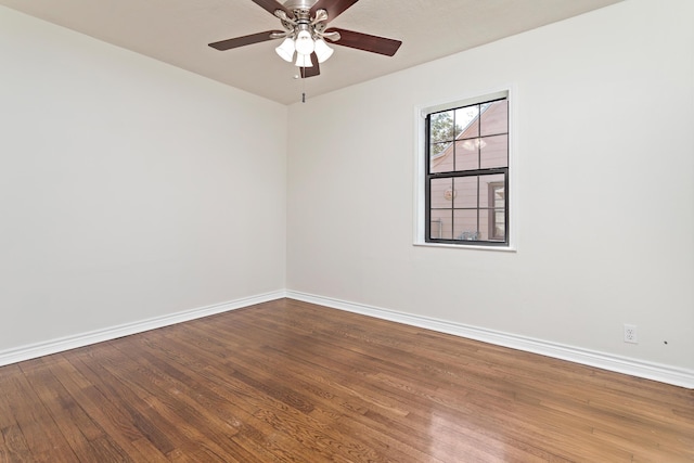 empty room with ceiling fan and hardwood / wood-style flooring