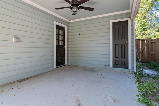 entrance to property featuring ceiling fan and a patio