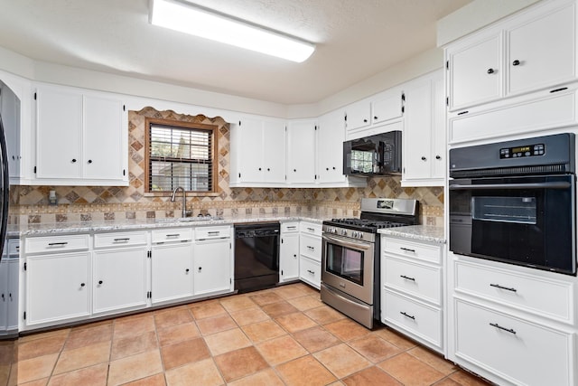 kitchen featuring black appliances, light tile patterned flooring, white cabinets, and light stone countertops