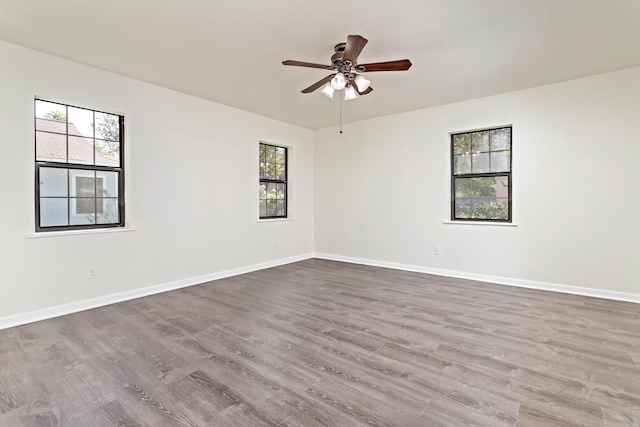 spare room with ceiling fan and wood-type flooring