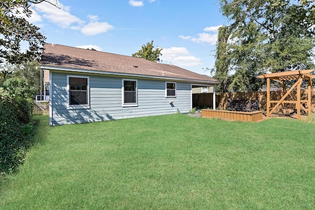 rear view of house with a yard