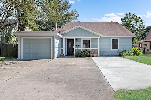 single story home featuring a porch and a garage