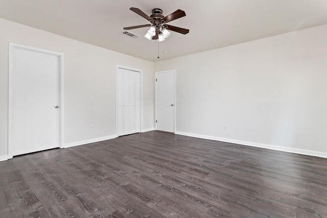 spare room with ceiling fan and dark wood-type flooring