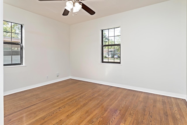 empty room featuring hardwood / wood-style floors and ceiling fan