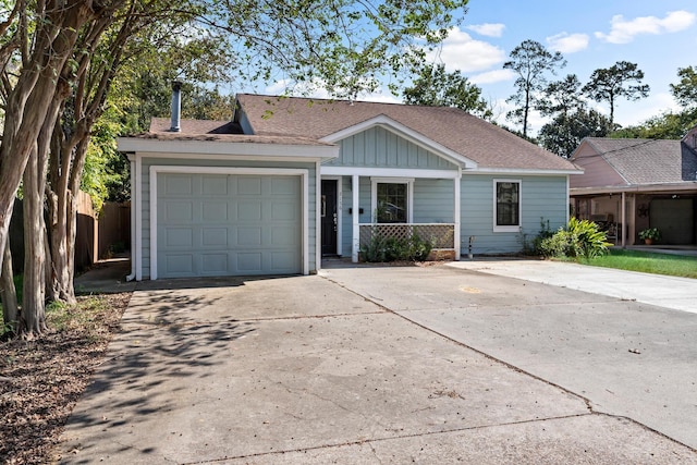 ranch-style home featuring covered porch and a garage