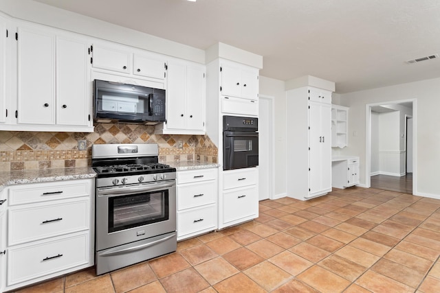 kitchen with decorative backsplash, white cabinets, black appliances, and light stone counters