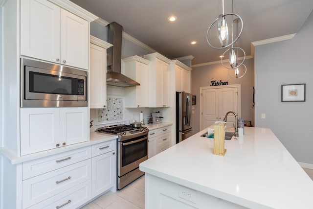 kitchen featuring crown molding, tasteful backsplash, appliances with stainless steel finishes, a sink, and wall chimney exhaust hood