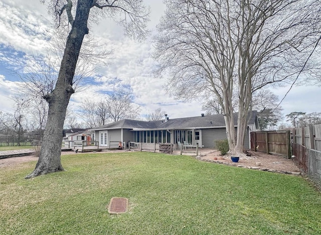 back of house with a yard, a patio, fence, and a wooden deck