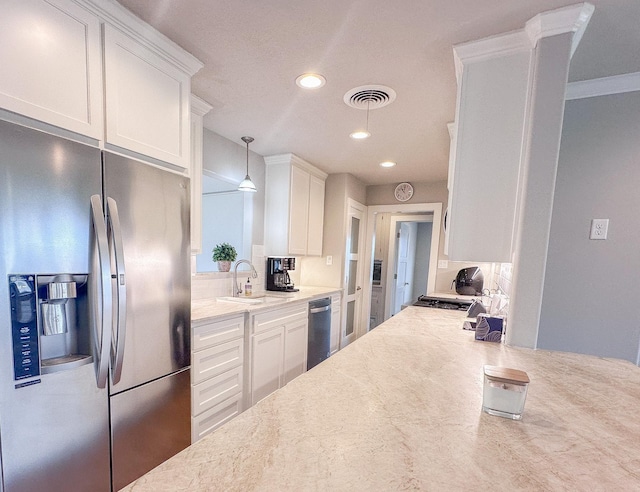 kitchen with white cabinets, visible vents, stainless steel appliances, and a sink