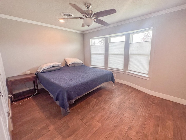 bedroom with crown molding, visible vents, ceiling fan, light wood-type flooring, and baseboards