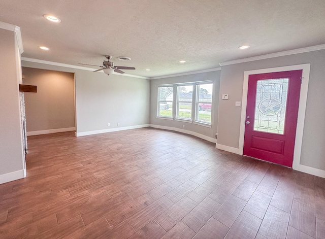 foyer featuring baseboards, wood finished floors, crown molding, a textured ceiling, and recessed lighting