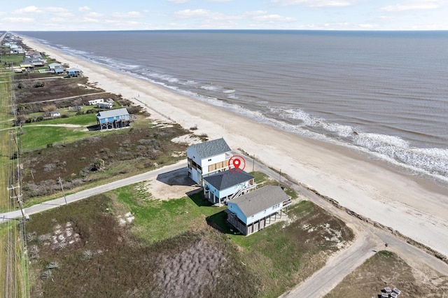 bird's eye view featuring a water view and a beach view