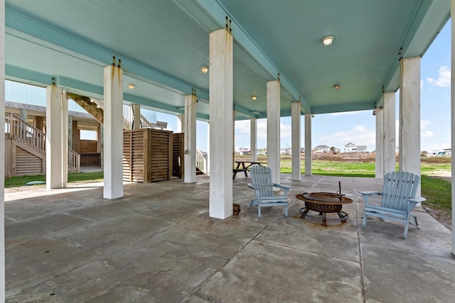 view of patio with stairway and a fire pit
