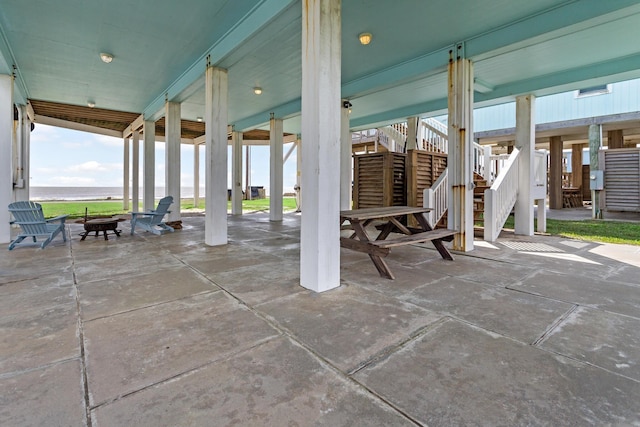view of patio / terrace featuring stairs and a carport