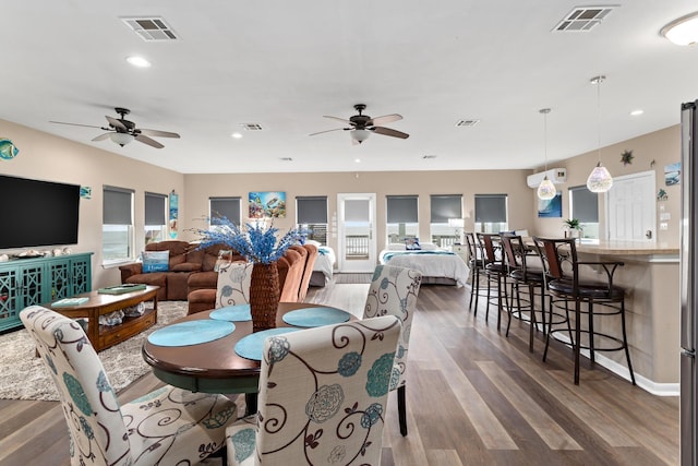 dining room featuring wood finished floors, visible vents, and recessed lighting