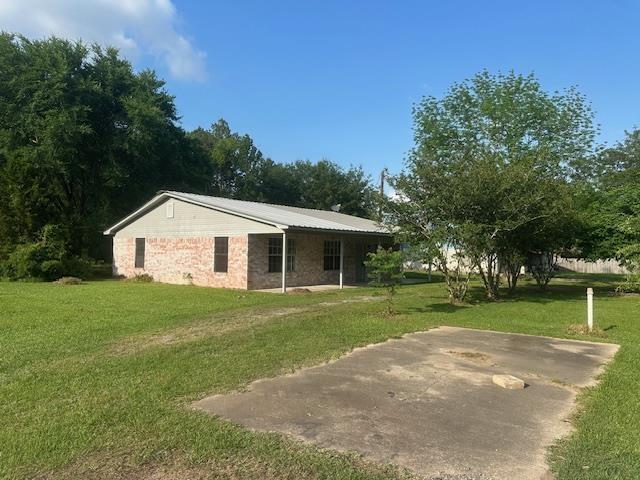 rear view of house with a yard