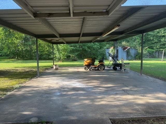 view of community with a patio area, a yard, and a carport