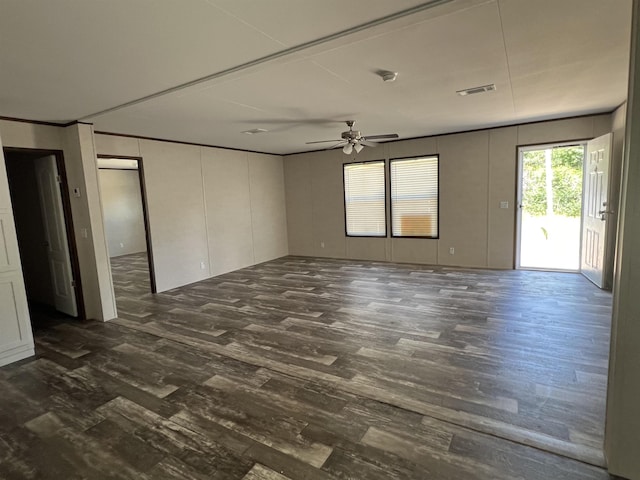 spare room featuring ceiling fan and dark wood-type flooring