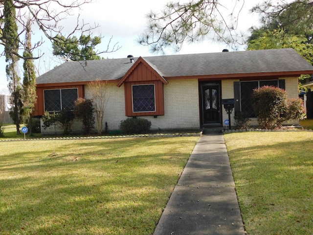 ranch-style home with a front lawn