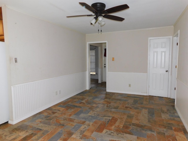 empty room with ceiling fan and ornamental molding