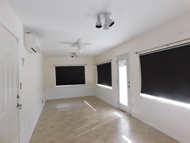 foyer entrance featuring an AC wall unit and ceiling fan