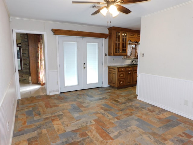 kitchen with french doors, ceiling fan, crown molding, and sink