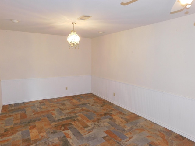 empty room with an inviting chandelier