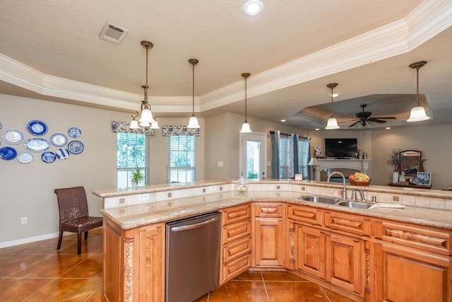 kitchen featuring a tray ceiling, sink, pendant lighting, dark tile patterned flooring, and dishwasher