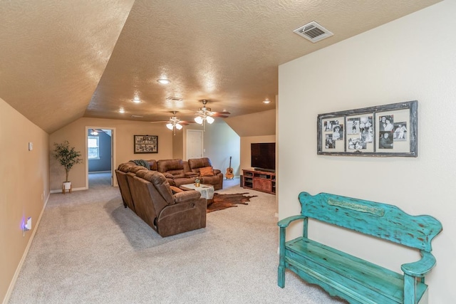 living room with carpet flooring, ceiling fan, a textured ceiling, and vaulted ceiling