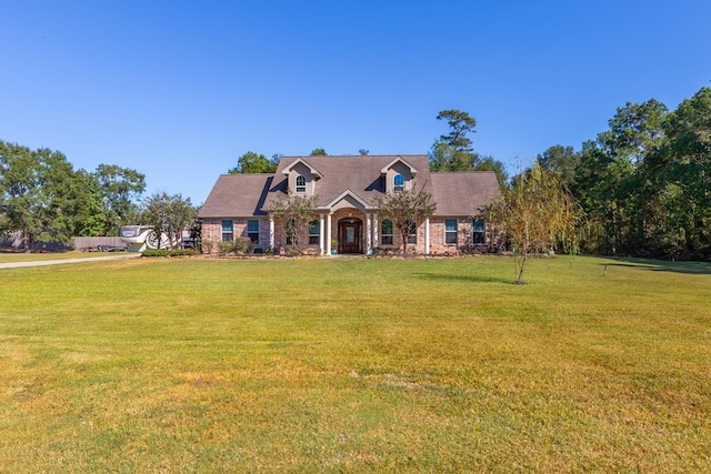 cape cod house with a front lawn