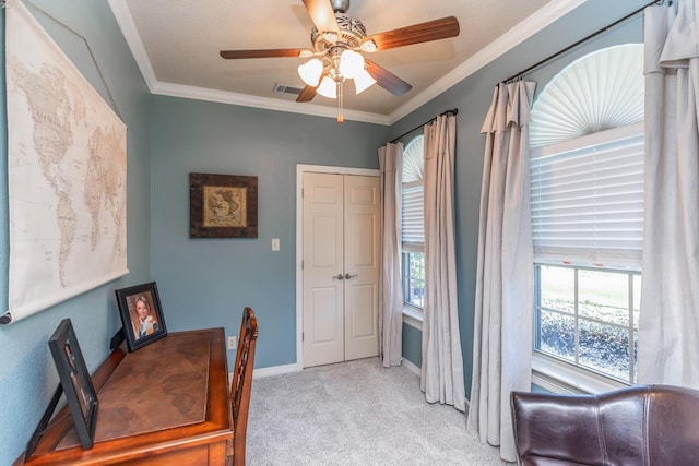 home office featuring a healthy amount of sunlight, crown molding, ceiling fan, and light colored carpet