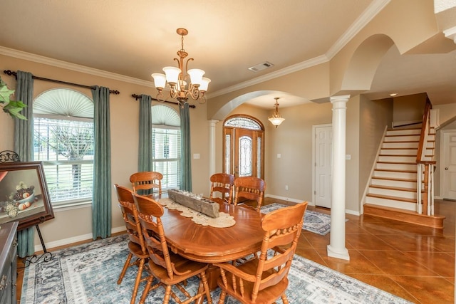 tiled dining room featuring a chandelier and ornamental molding