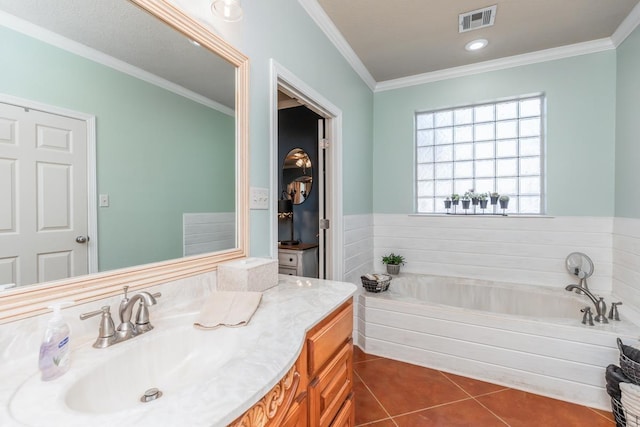 bathroom featuring a washtub, vanity, tile patterned floors, and crown molding