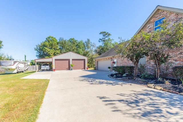 view of front facade with a carport, a garage, an outdoor structure, and a front lawn