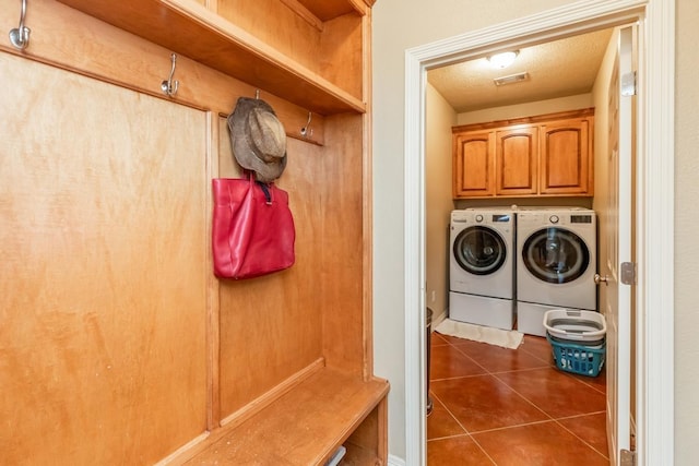 interior space with washing machine and dryer and dark tile patterned floors