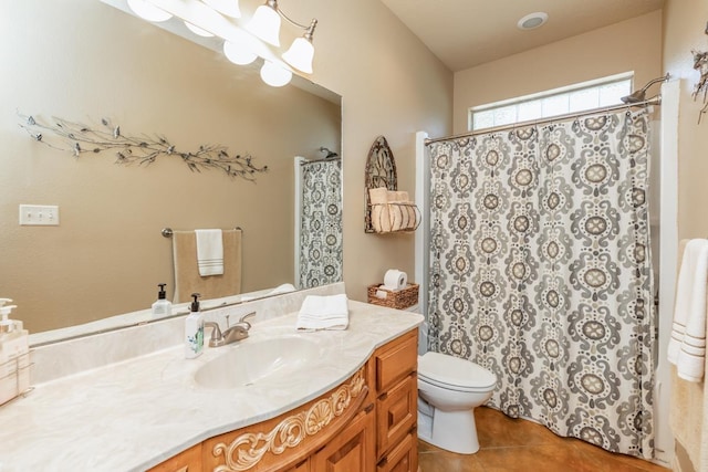 bathroom featuring tile patterned floors, vanity, toilet, and a chandelier