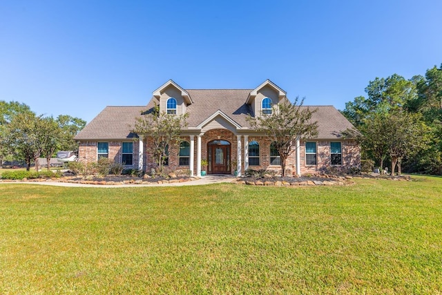 cape cod-style house featuring a front lawn