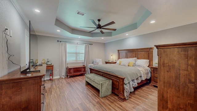 1405 Turner Dr, Bridge City, TX 77611 - bedroom featuring a raised ceiling, light wood-style flooring, recessed lighting, crown molding, and a ceiling fan