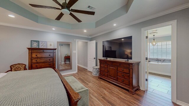 1405 Turner Dr, Bridge City, TX 77611 - bedroom featuring wood finished floors, a raised ceiling, recessed lighting, a ceiling fan, and ornamental molding