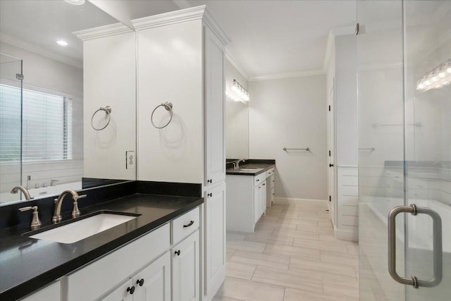 bathroom with vanity, crown molding, and a shower with shower door