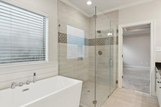 bathroom with vanity, crown molding, and shower with separate bathtub