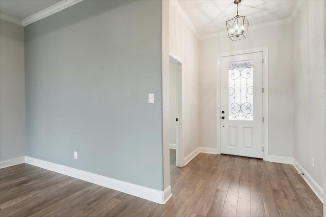 entrance foyer featuring a chandelier, hardwood / wood-style floors, and ornamental molding