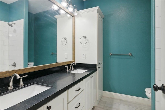 bathroom with tile patterned floors, vanity, and toilet