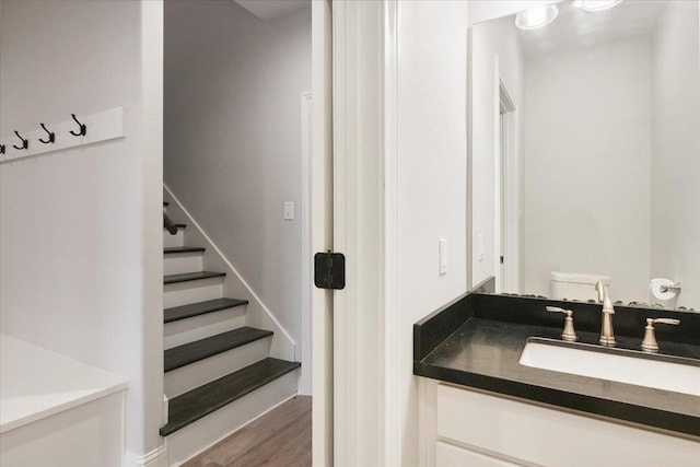 bathroom with vanity, wood-type flooring, and toilet