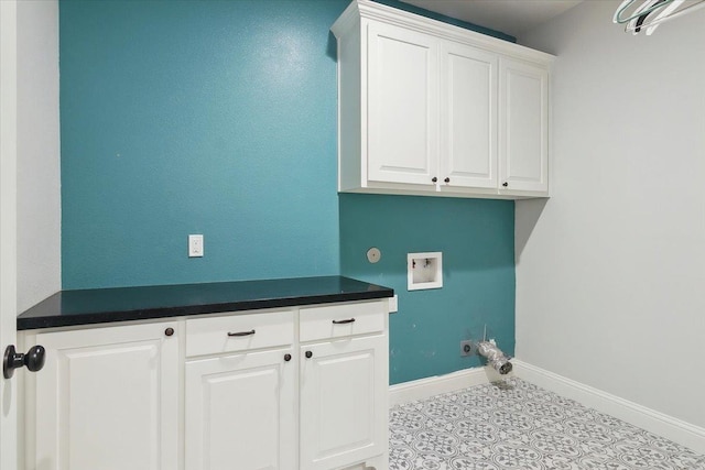 washroom with cabinets, washer hookup, and light tile patterned flooring