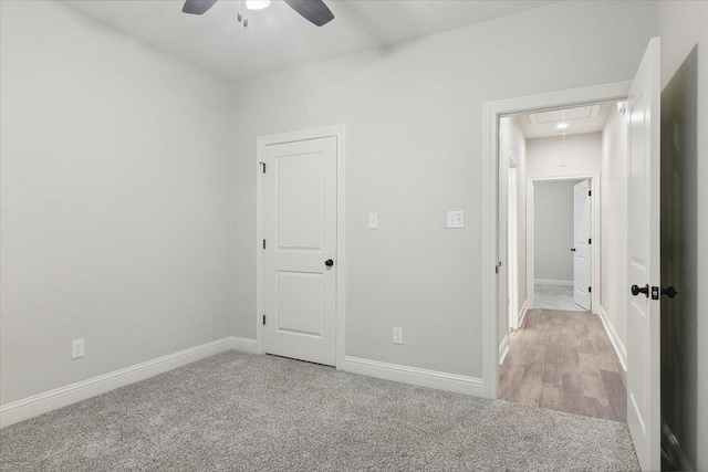 carpeted spare room featuring ceiling fan