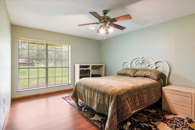 bedroom featuring light hardwood / wood-style flooring and ceiling fan